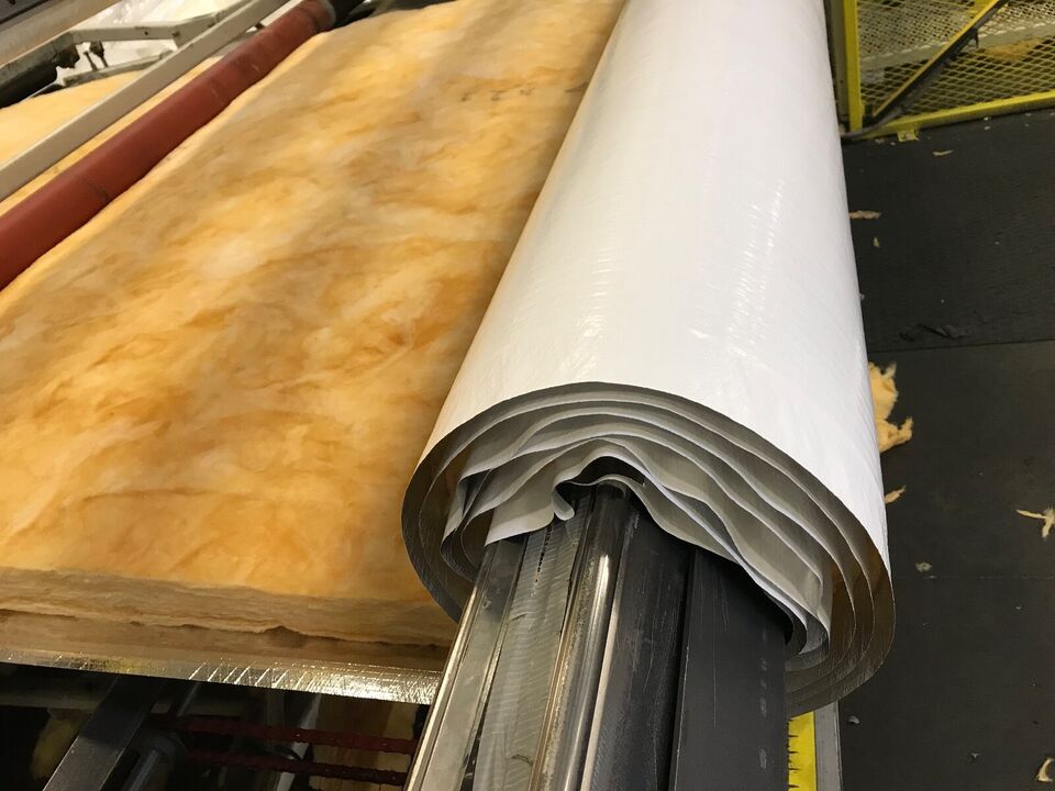 Vinyl-faced fiberglass insulation being laminated on a NAIMA-certified production line